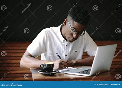Freelancer Working On Laptop Computer At Coffee Shop Stock Photo