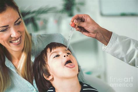 Homeopath Giving Remedy To Child Photograph By Microgen Imagesscience