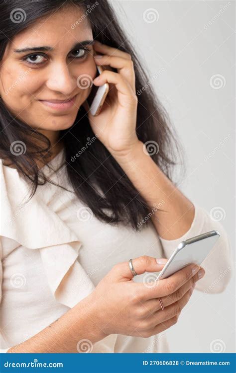Young Indian Woman Using Two Smartphones Stock Photo Image Of Focus