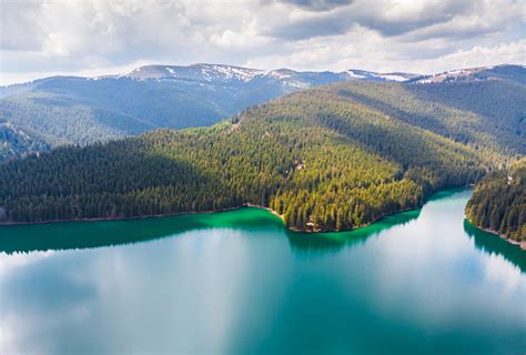 Aerial View Over Beautiful Turquoise Mountain Lake And Green Forest