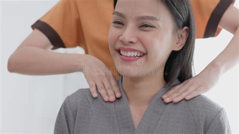 In A Spa And Beauty Parlor A Woman A Female Model Sits And Relaxes While Having Her Neck And