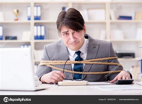 Businessman Tied Up With Rope In Office Stock Photo By ©elnur 166590230