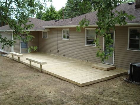 A Large Wooden Deck In Front Of A House