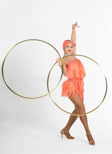 A Charming Girl Performs Circus Elements With A Hula Hoop Stock Photo