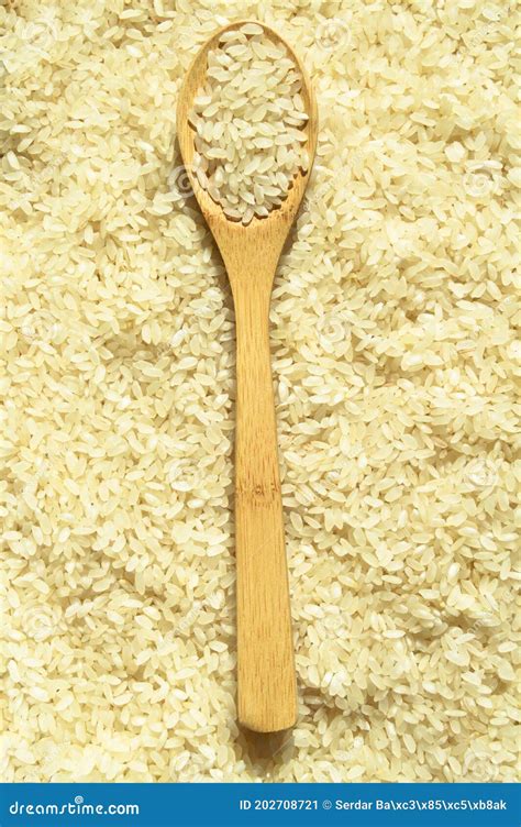Fresh Organic White Raw Rice Grains Texture And Wooden Spoon Uncooked