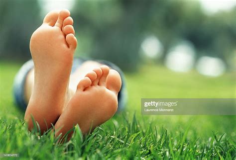 Young Woman Lying In Grass With Crossed Feet High Res Stock Photo