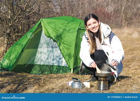 Cheerful Woman Camping Alone Cooking In Front Of Her Tent Time For