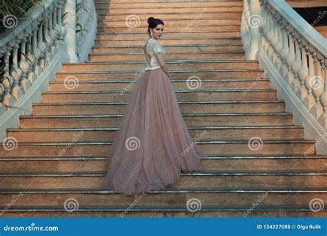Beautiful Lady In Luxurious Ballroom Dress Walking Up The Stairs Of Her