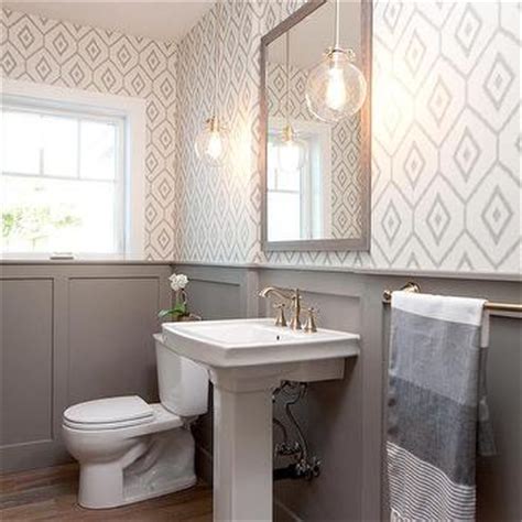 In a small powder room without much access to natural light—for example, a windowless space under the stairs—embrace the moodier, edgier atmosphere with the original wainscoting was painted in farrow & ball's plummet, which complements the paper and makes the powder room feel more formal. Grey Wash Wood Floors Design Ideas