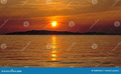 Sunset Over The Adriatic Seawith Silhouette Of An Island O The Horizon