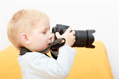 Boy Child Kid Playing With Camera Taking Photo At Home Stock Image