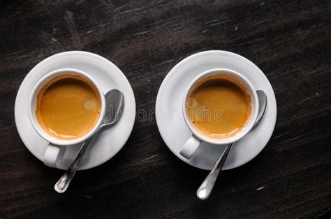 A coffee table is much more than a place for you to rest your wine glass at the end of the long day, it can tie together an entire room and be used as a focal piece to display all sorts. Two Coffee Cups On Table In Cafe Stock Image - Image of ...