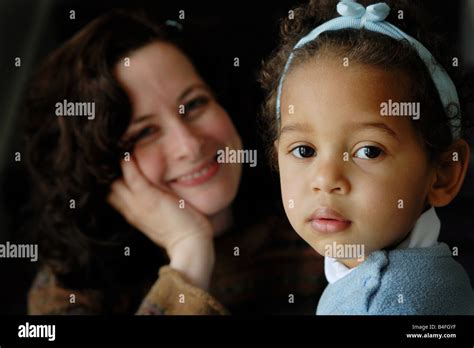 A Portrait Of An Adopted Preschool Biracial Girl With Her Smiling