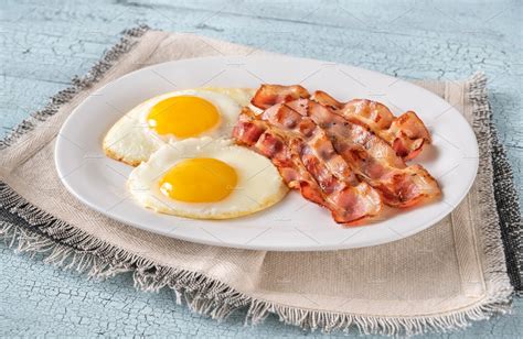 Fried Eggs With Bacon Stock Photo Containing Bacon And Board High