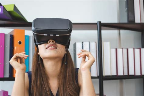 Relaxed Young Asian Woman Wearing Virtual Vr Reality Glasses On