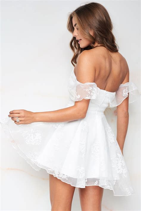 a flirty fit and flare dress featuring a pretty floral lace material overlay an off shoulder
