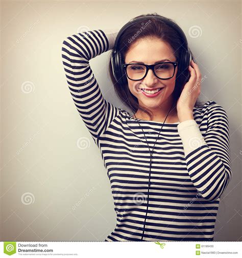 Happy Smiling Young Woman Listening Music Wearing The Headphones Stock