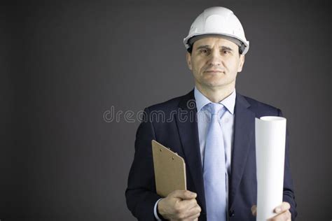 Construction Engineer In Hard Hat Holds Clipboard Blueprint Roll With