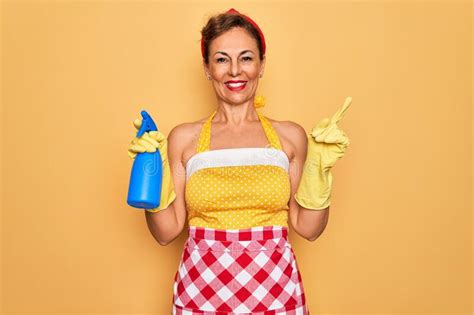 Middle Age Senior Housewife Pin Up Woman Wearing 50s Style Retro Dress Cleaning Using Spray Very