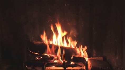 A Fire Burning In A Fireplace With Lots Of Flames