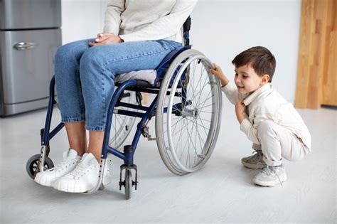 Free Photo Child Helping His Disabled Mother