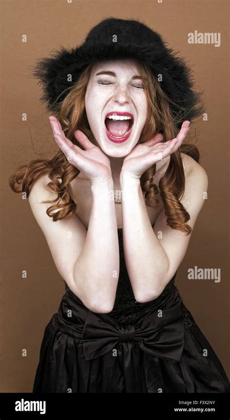 Woman Screams In A Brown Background Stock Photo Alamy