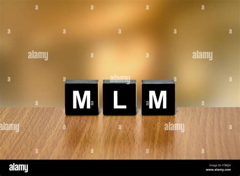Mlm Or Multi Level Marketing On Black Block With Blurred Background