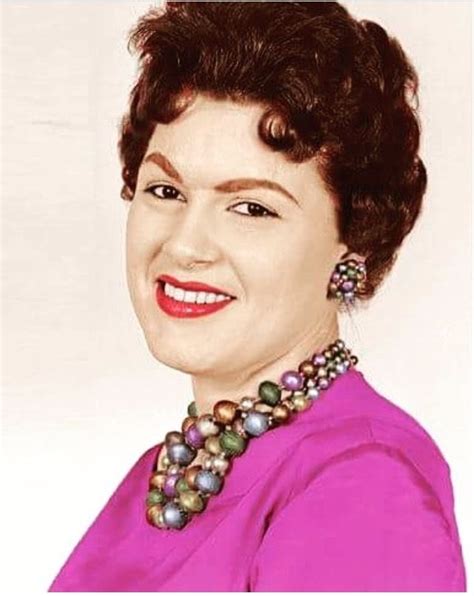 An Old Photo Of A Woman Wearing A Pink Shirt And Pearls On Her Necklaces
