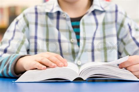 Close Up Of Schoolboy Studying Textbook Stock Image Colourbox
