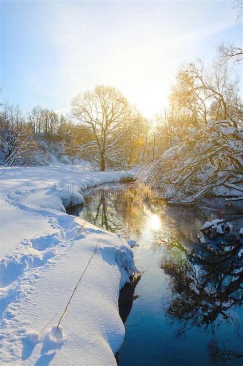 Sunny Winter Scene With River Stream And Sun Shining
