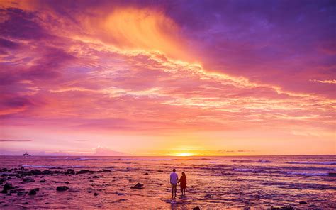 Couple Seeing Stunning Red Sunset at Beach