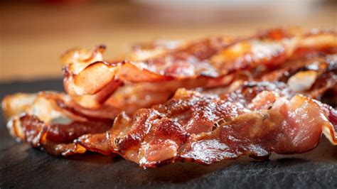 Remove the baking sheet from the oven and use tongs to carefully transfer the bacon to paper towels. The Trick Rachael Ray Uses When Baking Bacon