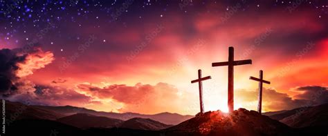 Three Wooden Crosses At Sunrise With Clouds And Starry Sky Background