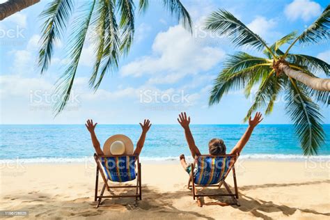 Happy Couple With Arms Up Relax On The Beach Enjoy Beautiful Sea On The