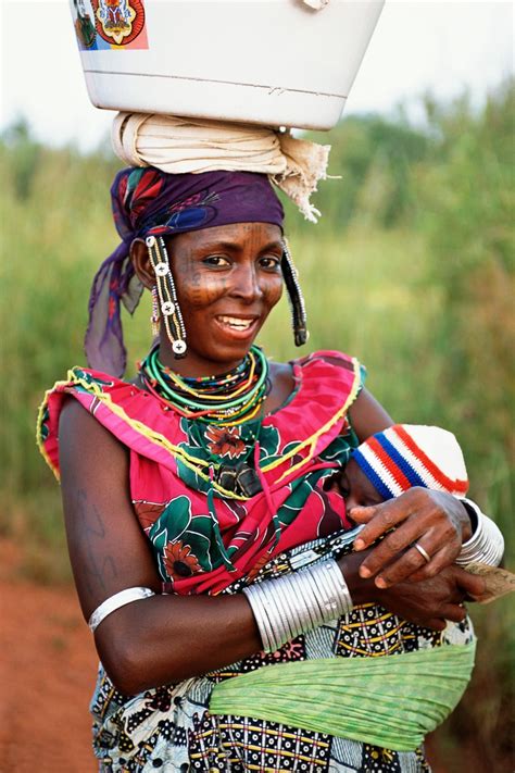 A Beninois Woman Returns From Getting Water With Her Baby