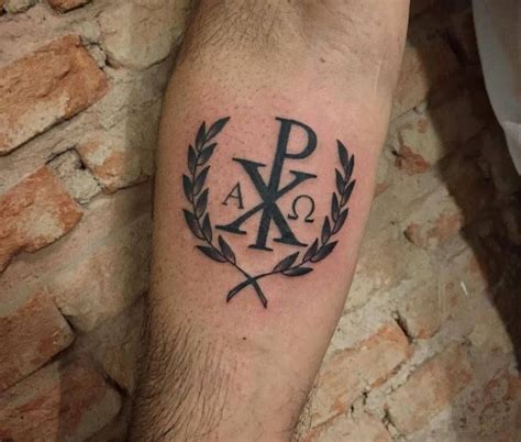 A Mans Arm With A Tattoo On It That Has The Letter K And Is Surrounded