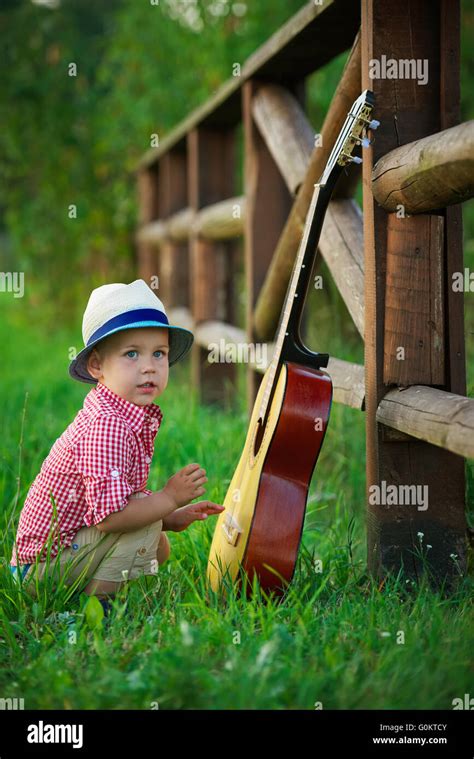 Cute Little Cowboy Playing Guitar Stock Photo Alamy