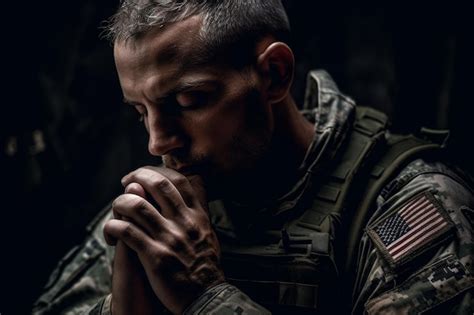 Premium Photo A Soldier Praying With The American Flag On His Jacket