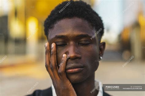 Young Black Man With Closed Eyes And Hand On Face — Person Eyes Closed