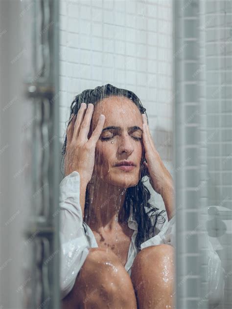 Premium Photo Depressed Woman With Dark Hair In Wet White Shirt And With Closed Eyes Sitting
