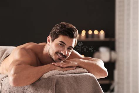Handsome Man Relaxing On Massage Table In Spa Salon Space For Text Stock Image Image Of