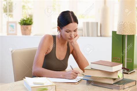 Pretty University Student Girl Studying At Home Sitting At Desk