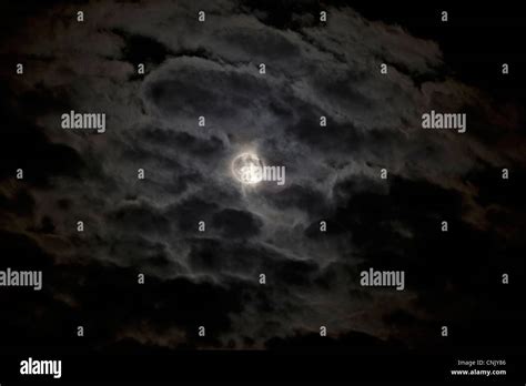 Full Moon Behind Clouds Stock Photo Alamy