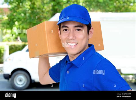 Smiling Friendly Delivery Man Carrying Parcel Box Stock Photo Alamy