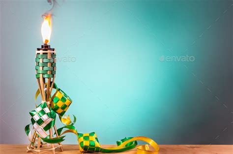 Traditional Malay Torch And Decorative Ketupat Lit Up During Hari Raya