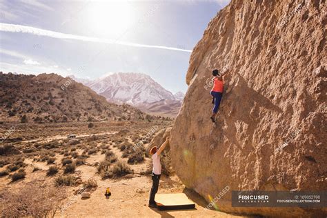 Couple Climbing Rock Face Buttermilk Boulders Bishop California Usa