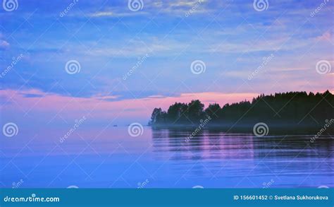 Lilac Seascape With Pink And Blue Clouds After Sunset Stock Photo