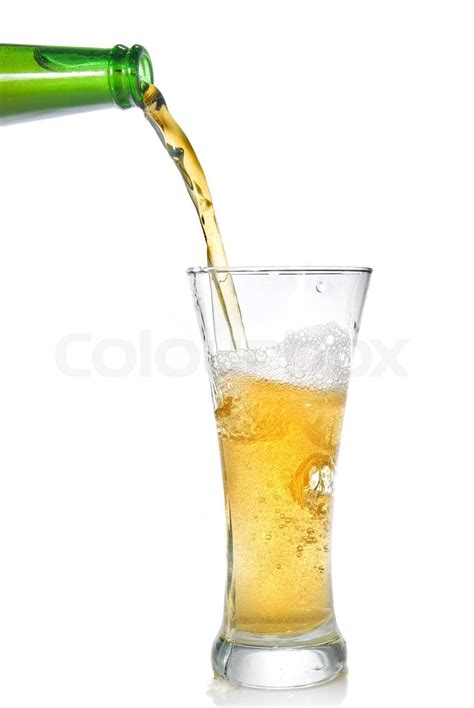 Beer Pouring From Bottle Into Glass Isolated On White Stock Image