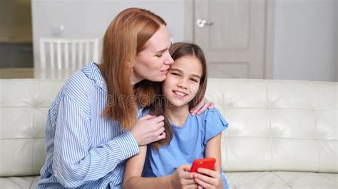 Mom Teaches Daughter To Use A Smartphone Watch Photos Videos Over The Internet Stock Video