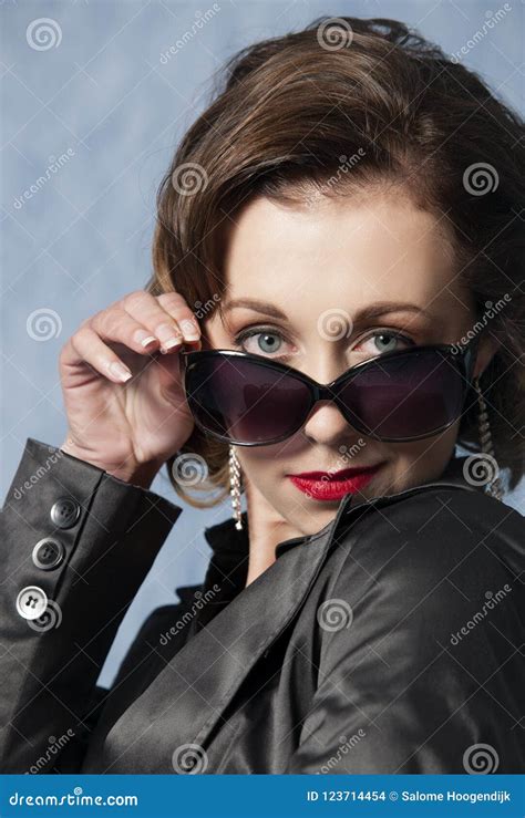 Sassy Woman Posing With Sunglasses Red Lipstick And A Jacket Stock